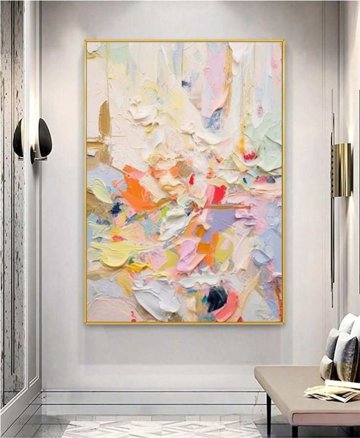 an abstract painting hangs on the wall above a bench