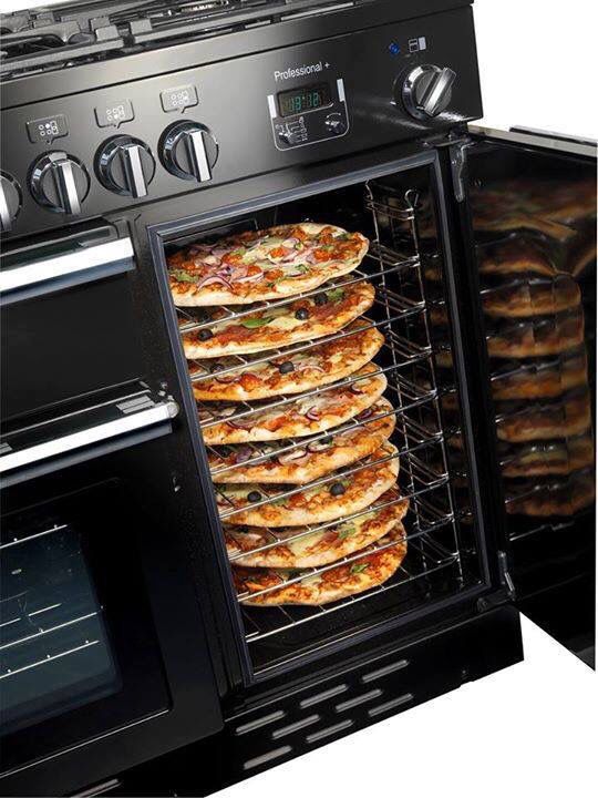 an open oven with several pizzas in it