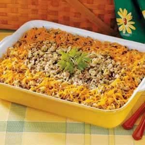 a yellow casserole dish filled with rice and ground beef