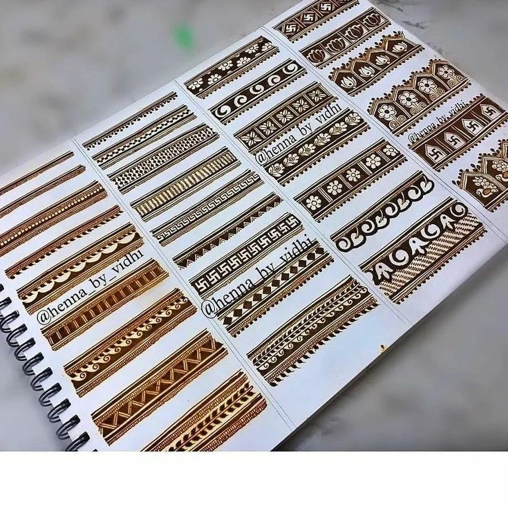 the stickers on this planner are gold and white, with intricate designs in them