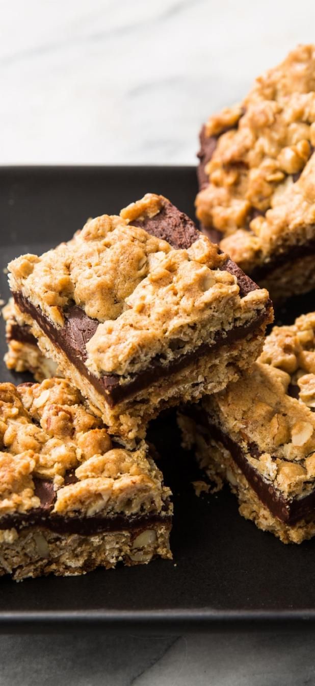 chocolate and oatmeal bars stacked on top of each other in a black plate