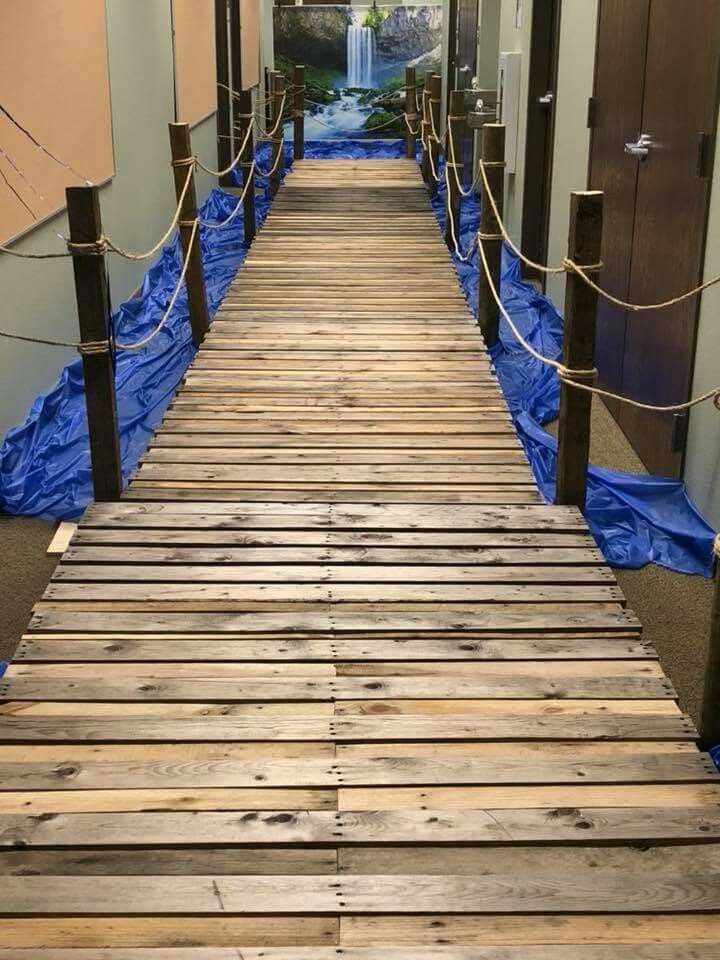 a wooden walkway with blue tarps on the sides and roped off around it