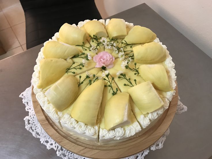 a cake with pineapple slices and flowers on it