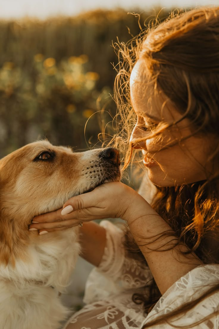 a woman is petting her dog outside