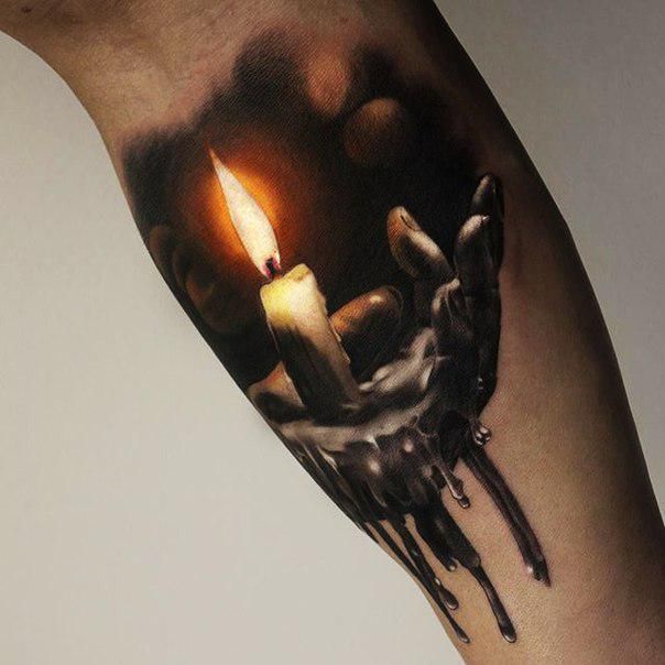 a person with a candle tattoo on their arm