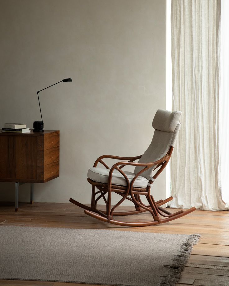 a rocking chair in front of a window