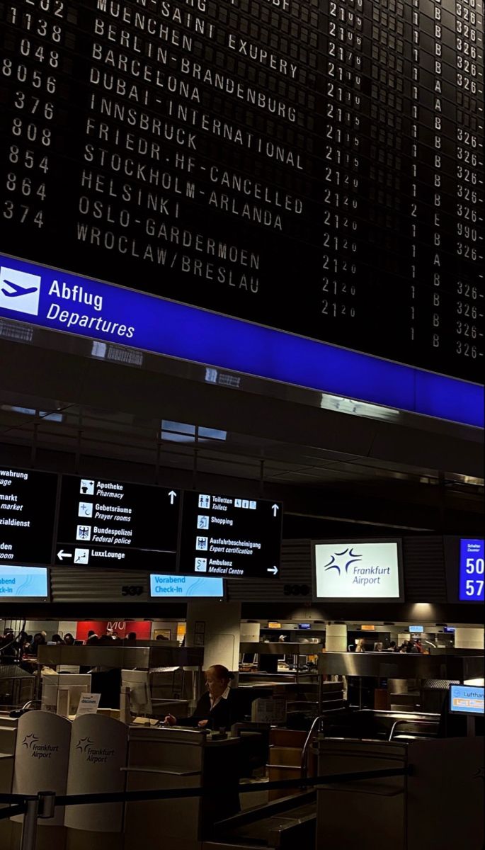 an airport terminal with lots of electronic information