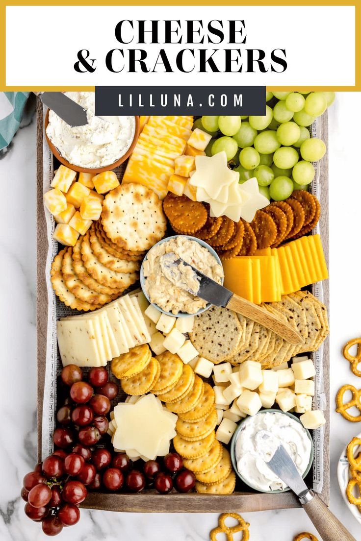 cheese and crackers platter with grapes, pretzels, crackers