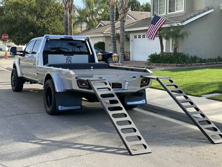 the truck is parked on the side of the road with its ladder attached to it