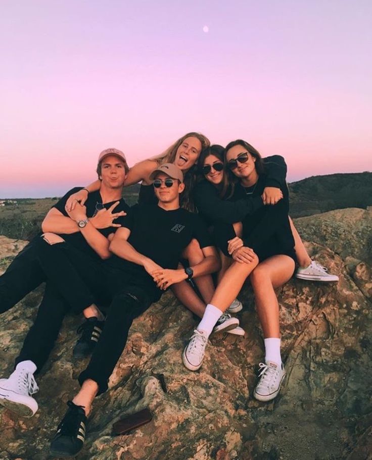 a group of people sitting on top of a rocky hill with the caption real friends who doesn't explore