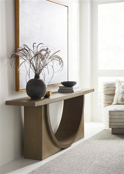 a modern console table with a vase on it