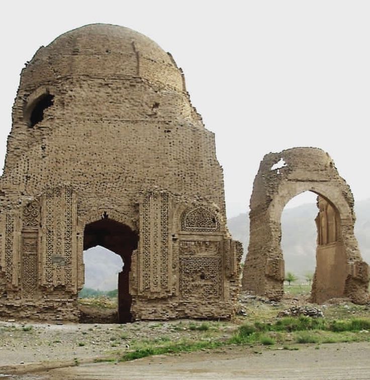 an old building that has been built into the ground with arches and doorways in it