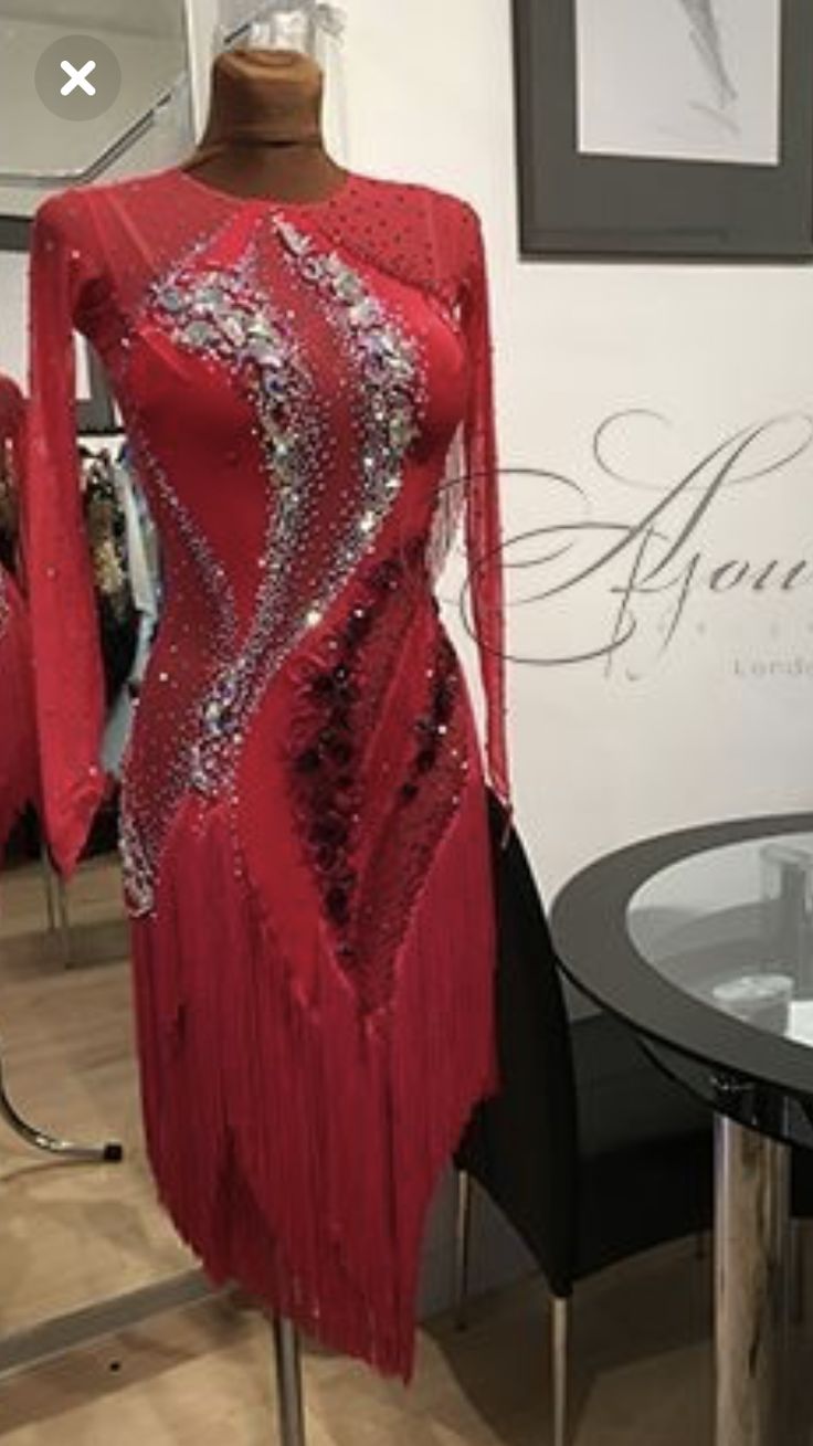 a red dress with sequins is on display