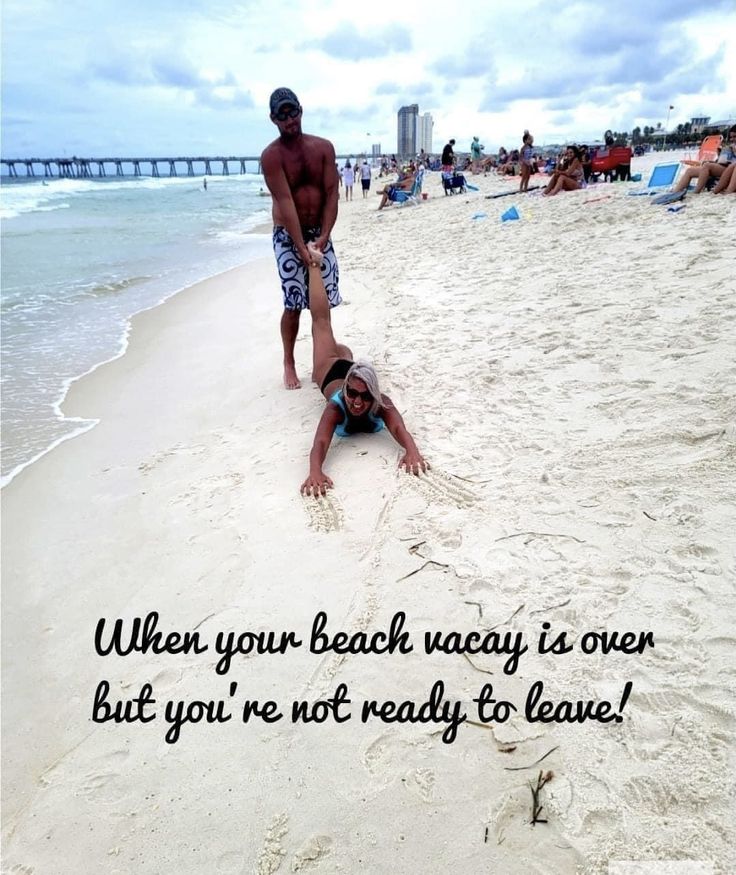 a man laying on top of a sandy beach next to the ocean with a message written below