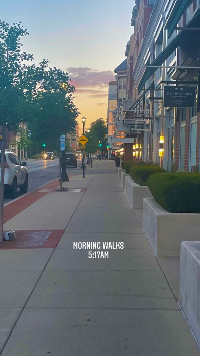 the sidewalk is empty and has no people walking on it at sunset or sunrise time