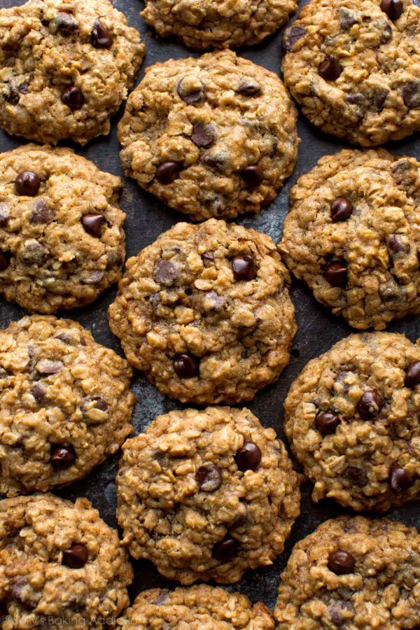 cookies with chocolate chips and oats on a baking sheet, ready to be eaten