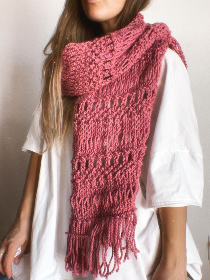 a woman wearing a pink knitted scarf