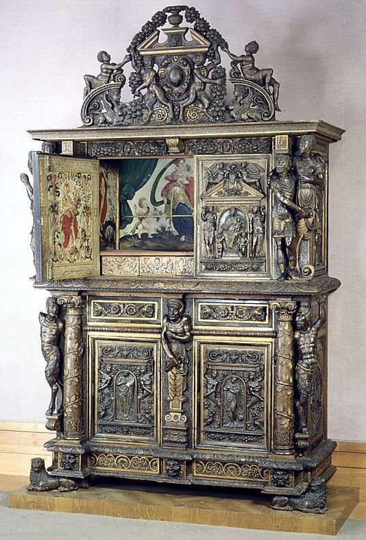 an ornate wooden cabinet with paintings on it