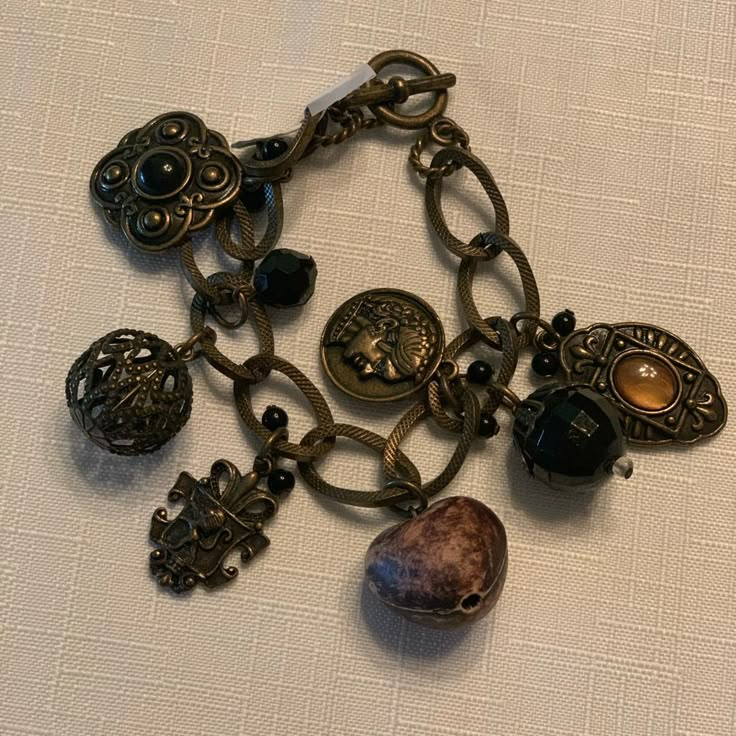 Fun Charm Bracelet In Gold/Bronze Tone. Black Accents. 7.5”. Vintage Black Nickel-free Bracelets, Adjustable Metal Bracelet With Vintage Charm, Adjustable Metal Bracelets With Vintage Charm, Vintage Black Beaded Bracelets, Jewelry Stack, Bronze Bracelets, Bronze Jewelry, Downtown Girl, Bronze Gold