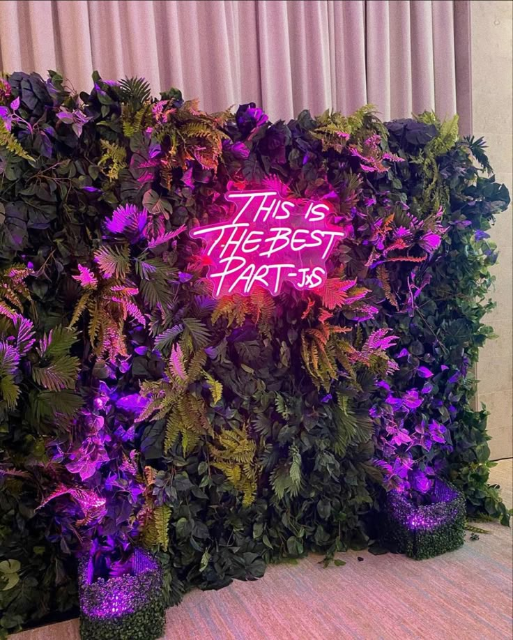 this is the best party sign in front of a wall with purple flowers and greenery