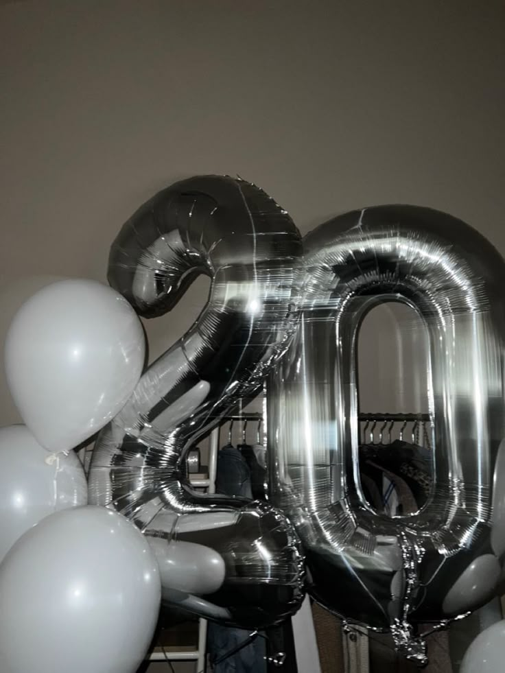 an image of the number 20 balloon in front of balloons that spell out it's fifty