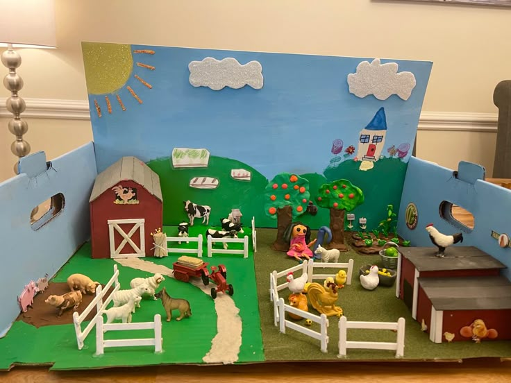 a toy farm with animals and horses in it's play area on the floor