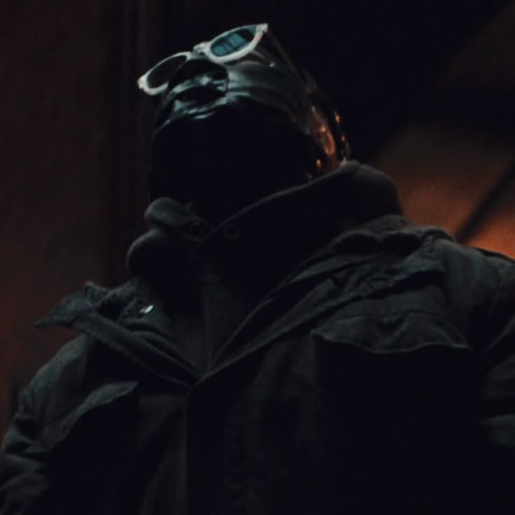 a man with goggles on his head in the dark