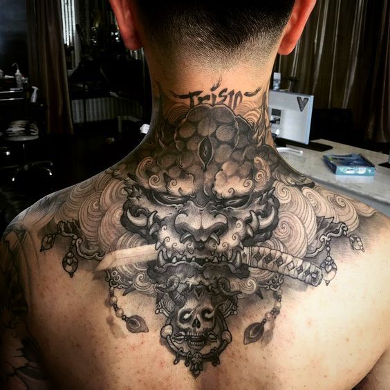 a man with a tattoo on his back