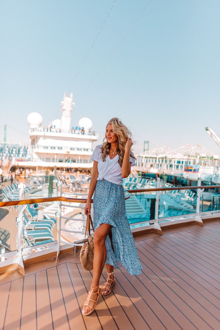 a woman standing on the deck of a cruise ship