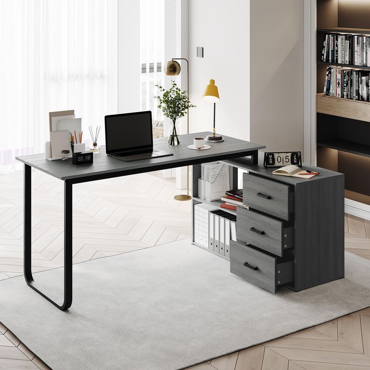 a desk with a laptop on it in front of a bookshelf