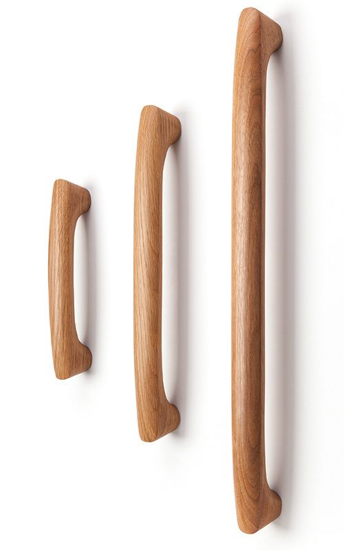 three wooden handles are shown against a white background and one is made out of wood