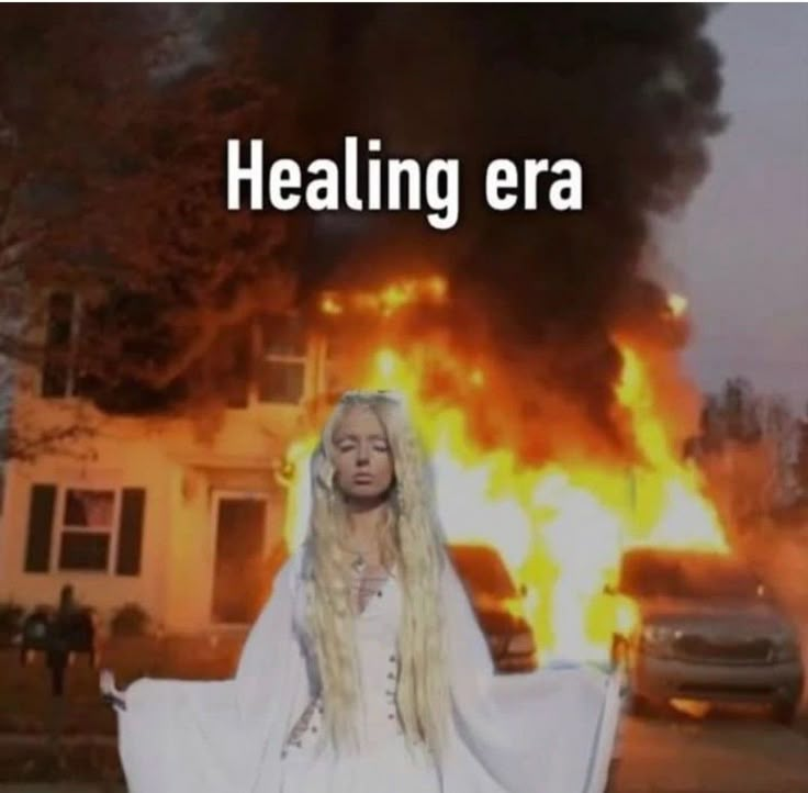 a woman standing in front of a fire with the words,'healing era '