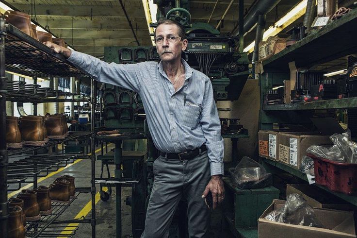 an older man standing in front of shelves with pots and pans on the shelves