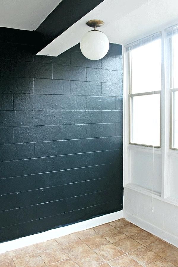 an empty room with black painted walls and white trim on the ceiling is pictured in this image