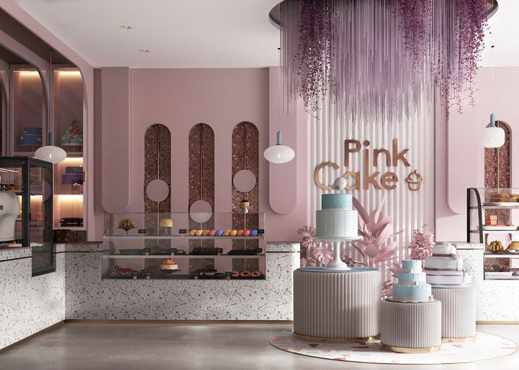 the interior of a pink cake shop with cakes on display