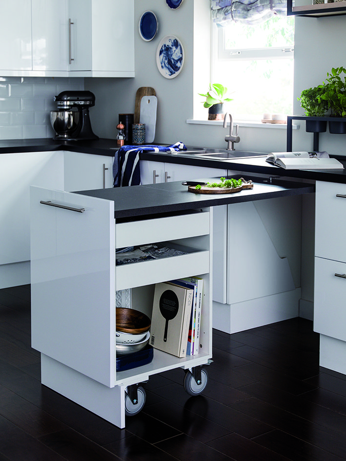 a kitchen with white cabinets and black counter tops