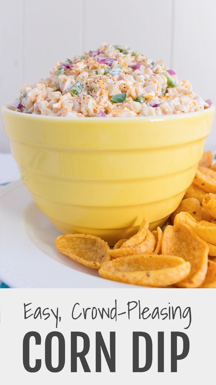 a yellow bowl filled with corn dip next to chips