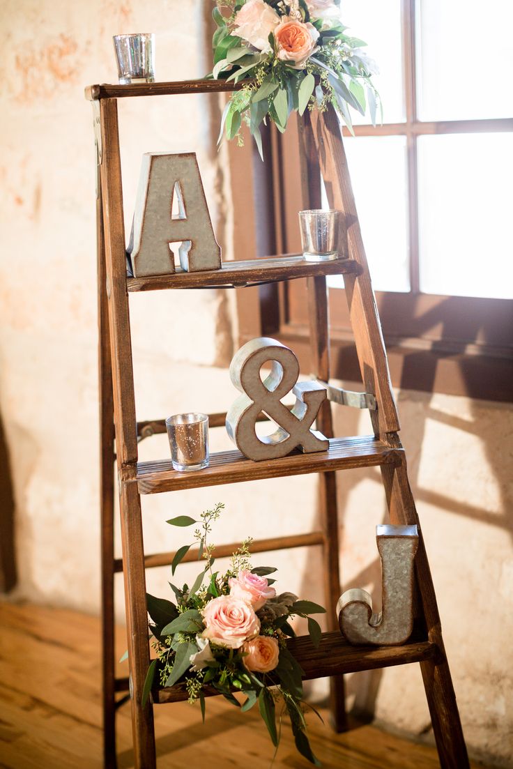 a wooden ladder decorated with flowers and candles