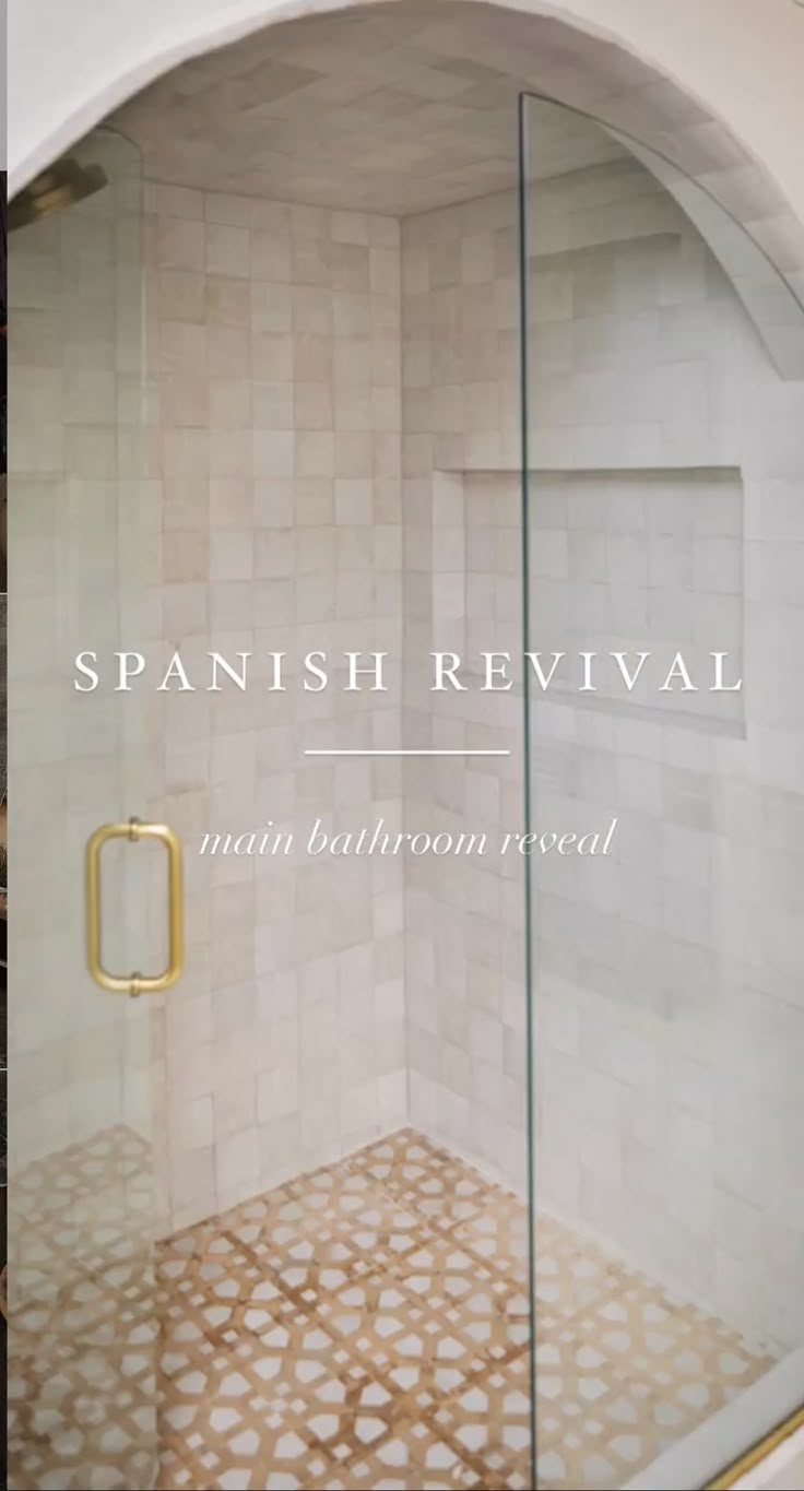 a bathroom with a glass shower door and tile flooring that reads spanish revival main bathroom reveal