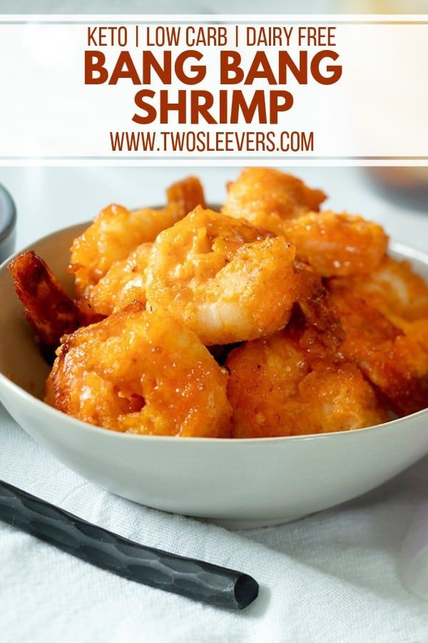 a white bowl filled with shrimp next to a fork