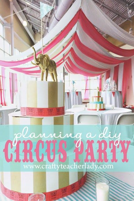 a circus themed birthday party with pink, white and gold striped cake on the table