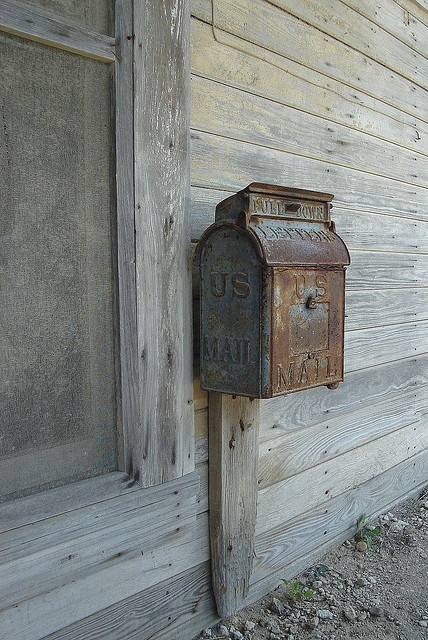 an old fashioned mailbox on the side of a building