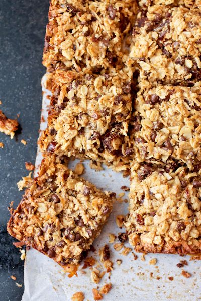 granola bars cut into squares on top of parchment paper