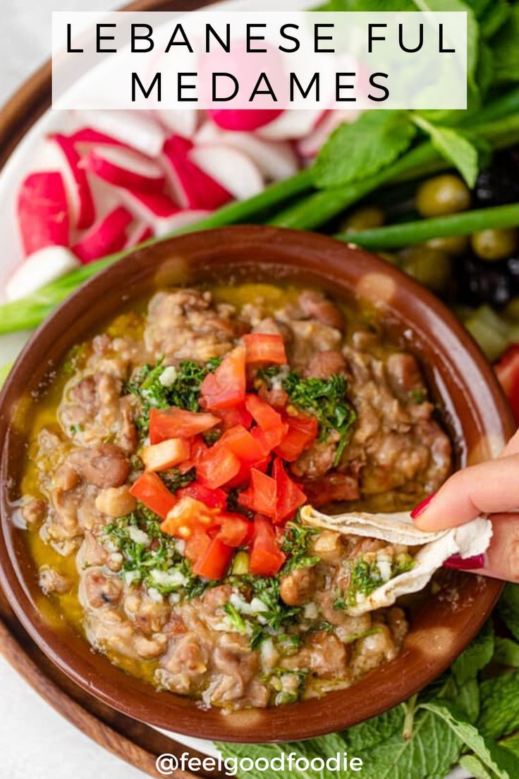 a person dipping some food into a bowl