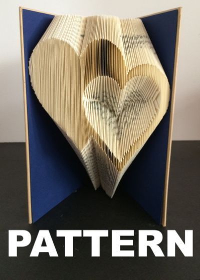 an open book with folded pages in the shape of a heart and text that reads pattern