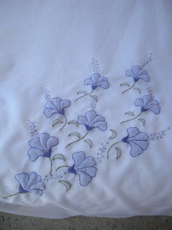 a white sheet with blue flowers on it