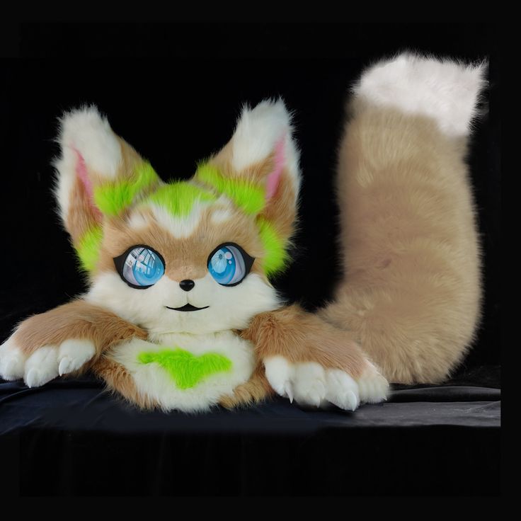 an orange and white cat with blue eyes sitting next to a stuffed animal on a black background