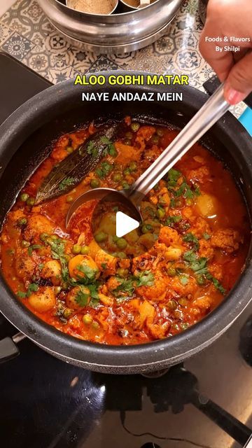 a person stirring food in a pot on the stove