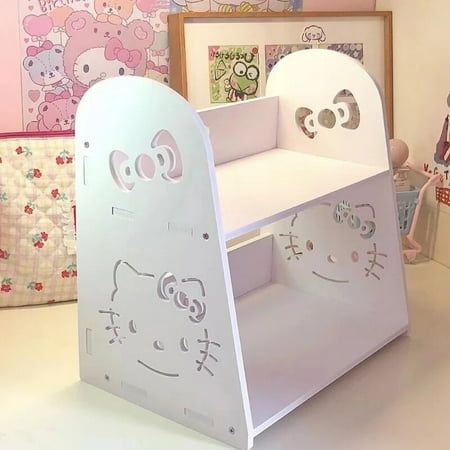 a child's book shelf with hello kitty cutouts on the front and sides