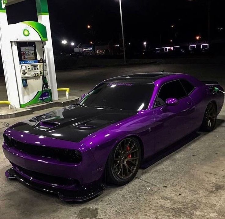 a purple car parked in front of a gas station